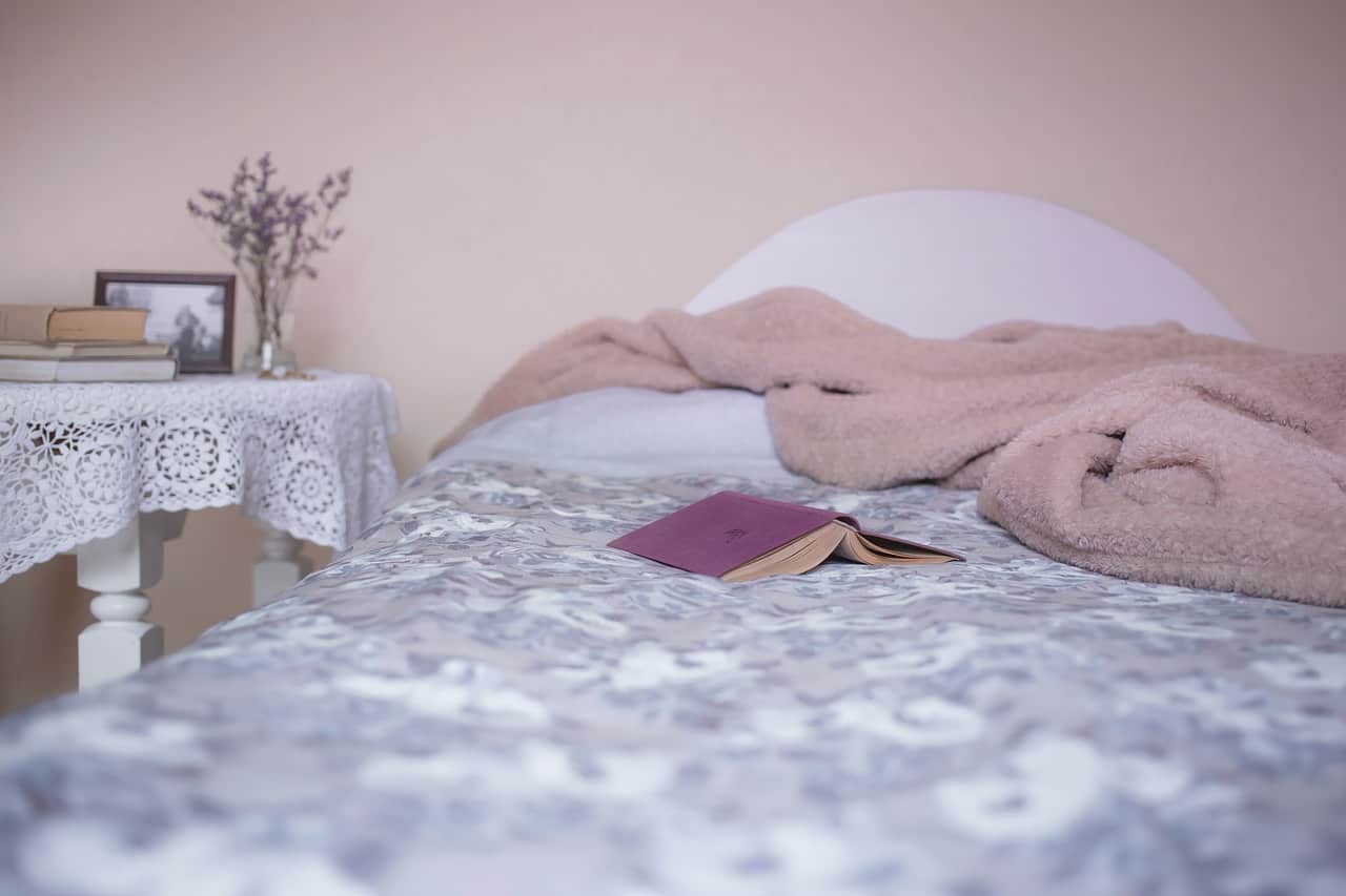 bed with book and comforter