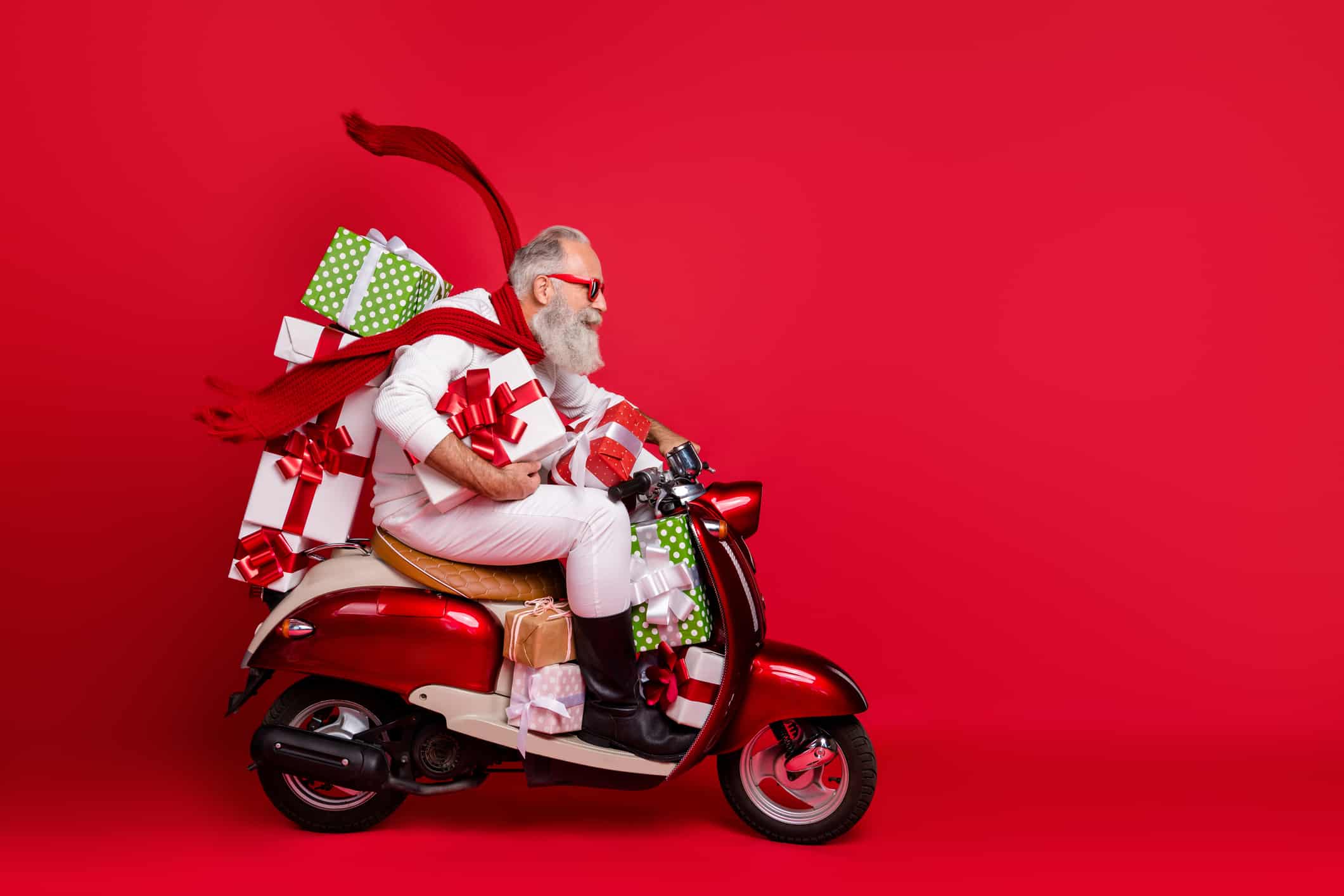 Older man on scooter surrounded with gifts