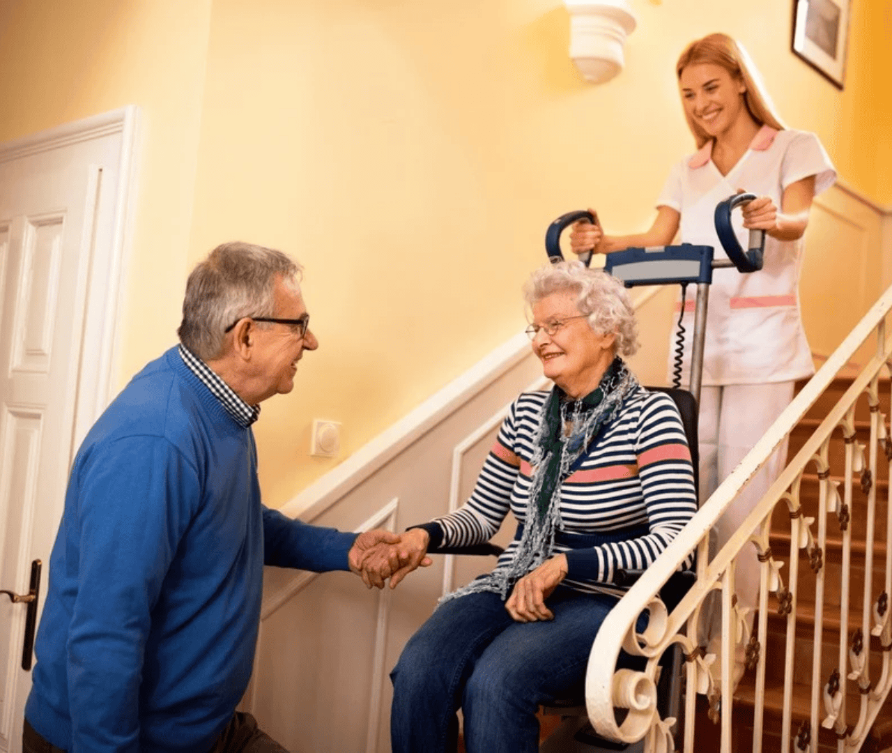 Elderly woman and caregiver discussing stairlift options at home.